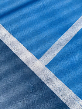 Blue sports court with white boundary lines
