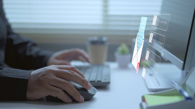 Email notification concept with businessman using computer mouse for digital communication and office correspondence