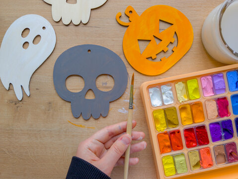 Halloween crafts for kids with wooden pumpkin, skull and ghost shapes, gouache paints and brush