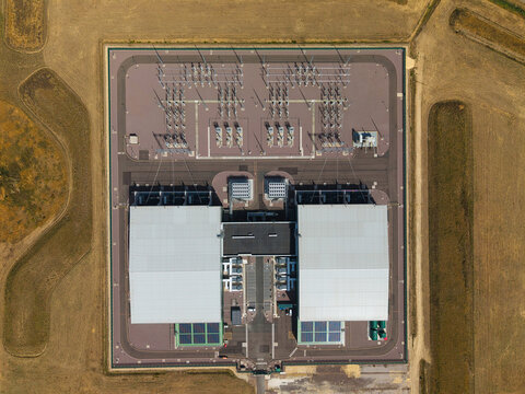 Aerial view of the Viking Link HVDC Converter Station showing the large converter halls, electrical switchgear, and surrounding infrastructure in Donington, England, United Kingdom.