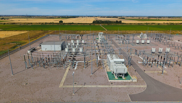 Aerial view of Triton Knoll offshore windfarm 400220kV substation with transformers and switchgear surrounded by agricultural fields in Boston, England, United Kingdom.