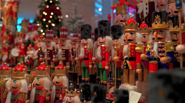 Selection of wooden nutcracker figurines displayed on shelves during christmas holiday shopping season.