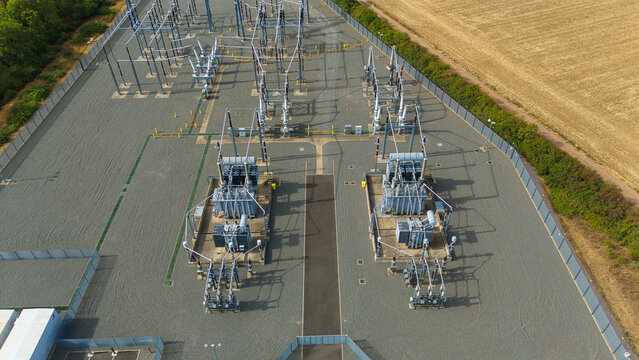 Aerial view of National Grid Ryhall Substation 400kV featuring large electrical transformers and switchgear equipment set within a gravel compound in Ryhall, England, United Kingdom.