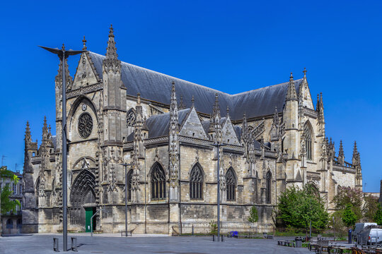Three-quarter view of the Gothic Basilica of Saint Michael in Bordeaux, France. Bright daylight highlights historic stone facade