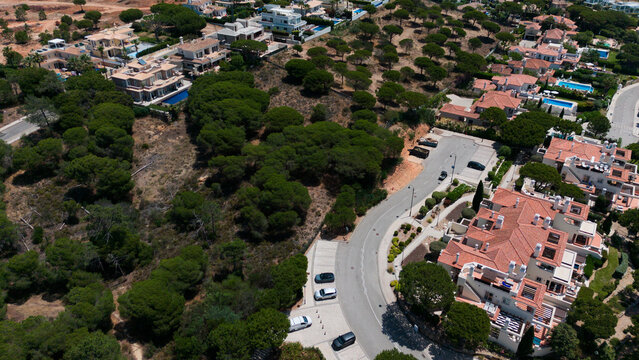 Aerial drone footage, shooting the tourist village of Vale de Lobo, on the shores of the Atlantic Ocean, golf courses for tourists. Portugal, Algarve.