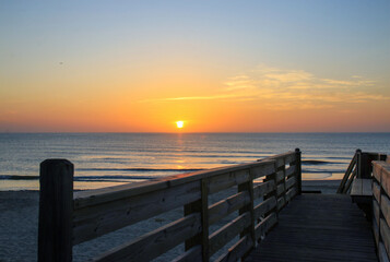 Fototapeta premium Sunrise Over Corolla Beach in North Carolina With Wooden Walkway