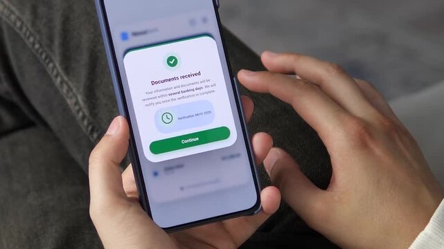 Mobile banking user responds to an AML compliance request and submits documents, reflecting tighter fintech regulation, KYC checks and the push for secure digital finance.
