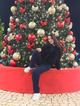 girl next to the tree with a Christmas gift