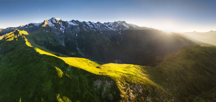 Sunset over Mountain green landscape with snow peak - South Caucasus, Republic of Georgia, Samegrelo - Zemo Svaneti.