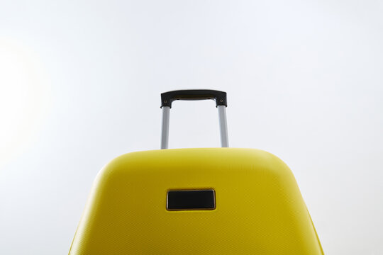 Yellow suitcase handle isolated on white background