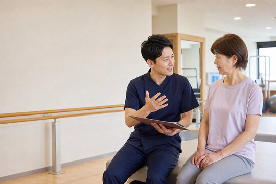 Physical Therapist Advising Mature Patient