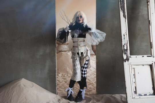 Full length lookbook shot of avant garde harlequin costume with corset and tulle sleeves