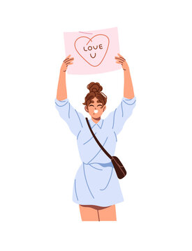 Happy girl holds board with love declaration above head. Young woman with card is waiting for in airport. Person with paper banner with text. Smiling girl with poster in arms. Woman raises up board