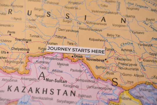 Journey Starts Here on Omsk Map Close Up Travel Planning and Destination Discovery Concept