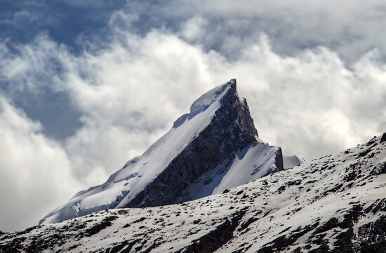 Aerial view of the snow-capped Urdukas peak rising above the rugged terrain of the Karakorum range in Karakorum, Pakistan.
