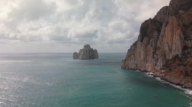 Pan di Zucchero Sea Stack Rising From The Mediterranean Coast Near Porto Flavia On Masua On The Coast Of Sardinia, Italy. Aerial Shot