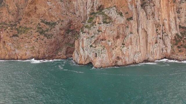 Porto Flavia Industrial Mining Installation Carved Into The Sheer Limestone Cliffs Near Masua In Southwestern Sardinia, Italy. Aerial Shot