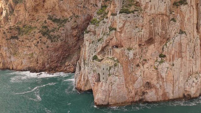 Porto Flavia Carved Into Sheer Limestone Cliffs Near Masua In Southwestern Sardinia, Italy. Aerial Shot