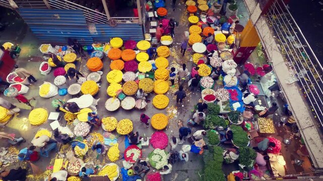 Aerial video of the vibrant KR Flower Market in Bangalore, Karnataka, India, showing a busy wholesale market with colorful flowers, vendors, traders, and traditional Indian commerce.
