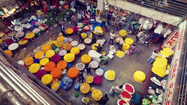 Aerial video of the vibrant KR Flower Market in Bangalore, Karnataka, India, showing a busy wholesale market with colorful flowers, vendors, traders, and traditional Indian commerce.