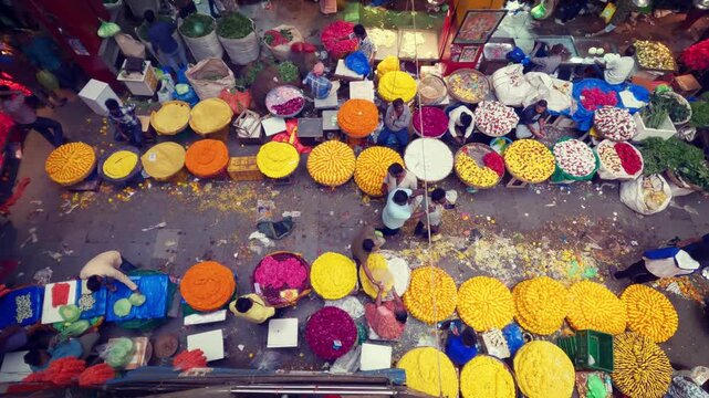Aerial video of the vibrant KR Flower Market in Bangalore, Karnataka, India, showing a busy wholesale market with colorful flowers, vendors, traders, and traditional Indian commerce.