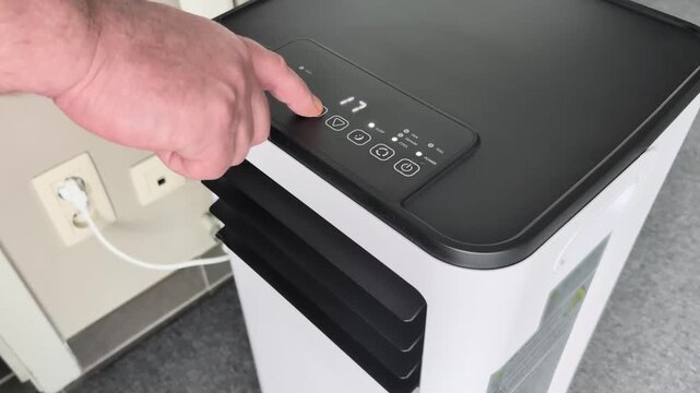 Setting timer on floor standing room air conditioner for three hours in home office location