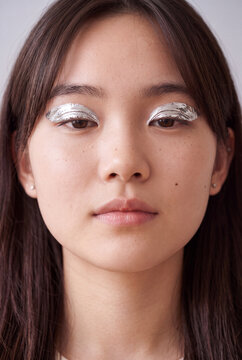 Closeup young woman metallic eyelid makeup for beauty portrait background and experimental fashion design