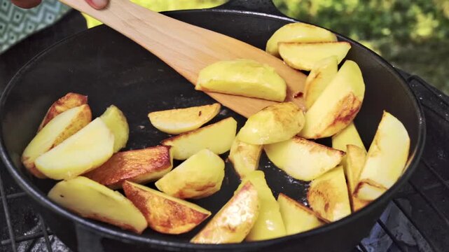 Cookware Utensil Moves Potatoes To Evenly Brown, Wooden Spatula Continuously Stirs And Flips Potato Pieces To Achieve Perfect Golden Color And Crispiness