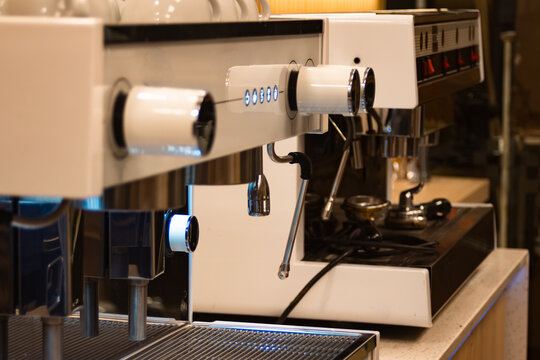 Professional espresso machine brewing aromatic coffee in a modern cafe, showcasing baristas preparing hot beverages with high-quality equipment and steam wands