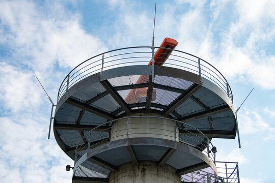 Radar tower at Frankfurt Main Airport, Germany, equipped with distinctive orange Airport Surveillance Radar system, ASR antenna for monitoring airspace, air traffic control
