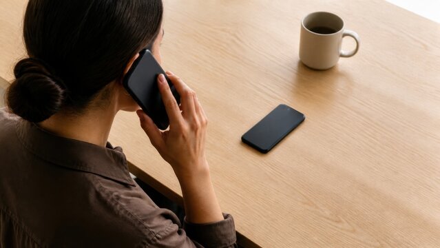 Bank callback verification: A customer uses a separate unbranded phone to contact a financial institution while the original device lies face down