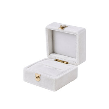 Elegant open white velvet jewelry box with golden clasps and hinges is presented on a clean white background