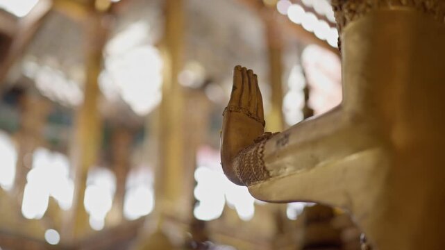 Numerous golden Buddha statues inside a serene temple hall. High-detail 4K B-roll shot showing Thai Buddhist culture, religion, and spiritual art.
