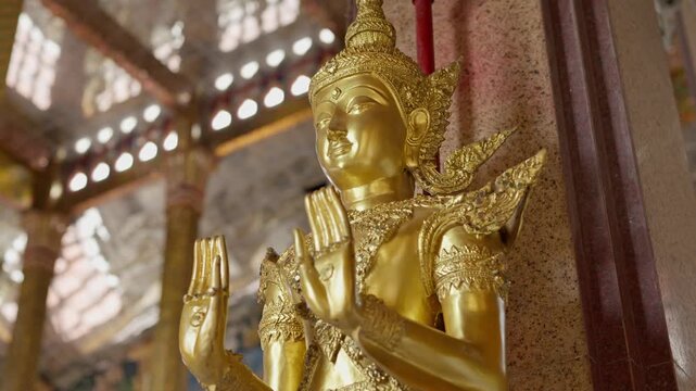 Numerous golden Buddha statues inside a serene temple hall. High-detail 4K B-roll shot showing Thai Buddhist culture, religion, and spiritual art.