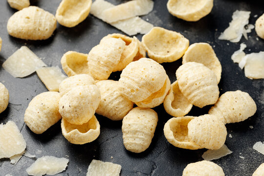 Hummus Chips with Italian Cheese and Black Pepper on dark background