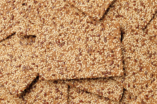 Wholegrain Crispbread with Sesame and Flax Seeds on Dark Surface