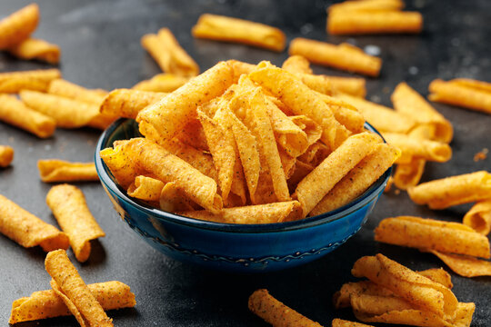 Rolled Tortilla Corn Chips in Blue Bowl on dark background