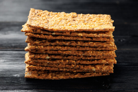 Wholegrain Cheese Crispbread with Mixed Seeds on Dark Background