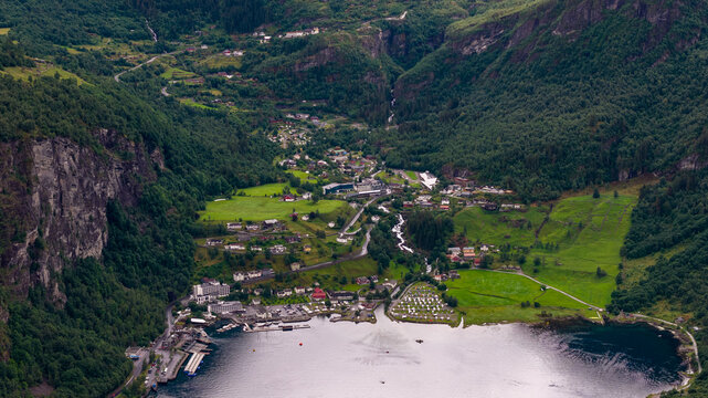 Aerial view of Geirangerfjord valley with river, settlements and forested slopes, Norway