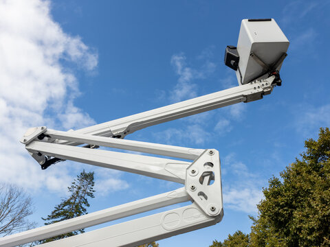 Elevated Boom Lift Bucket. Aerial Work Platform, Industrial Construction Equipment, Safe Working at Height, Maintenance Access, Outdoor Utility, Engineering, and Infrastructure Concept