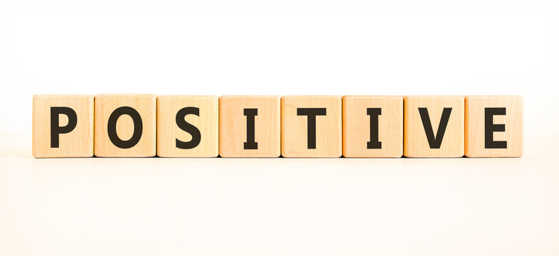 Positive word symbol. Concept word Positive on beautiful wooden blocks. Beautiful white background. Business support help positive word concept. Copy space.