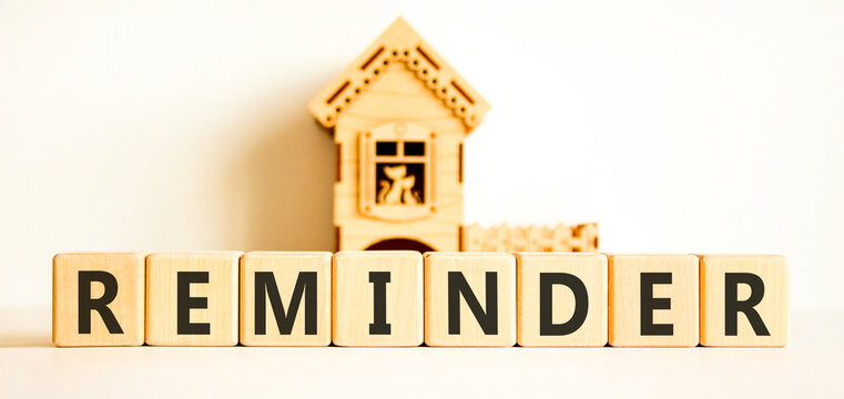 Reminder word symbol. Concept word Reminder on beautiful wooden blocks. Beautiful white background. Beautiful miniature wooden house. Business support help reminder word concept. Copy space.