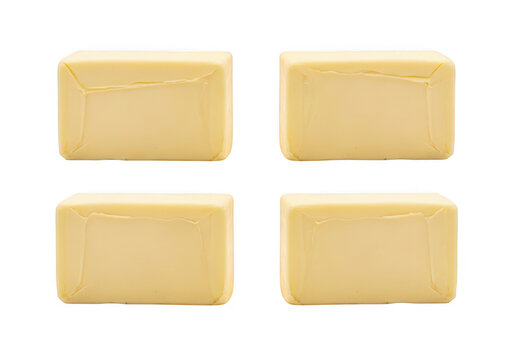 Four blocks of butter are arranged on transparent background dairy