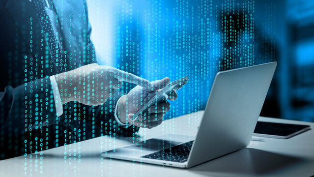 Businessman using smartphone and laptop with binary code overlay, representing cyber security and digital data technology. Concept of programming or technology digital data