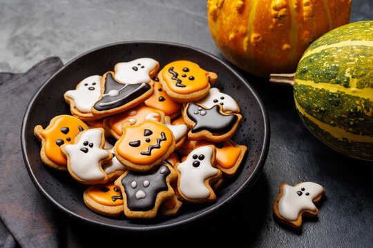 Halloween cookies on black stone background with copy space