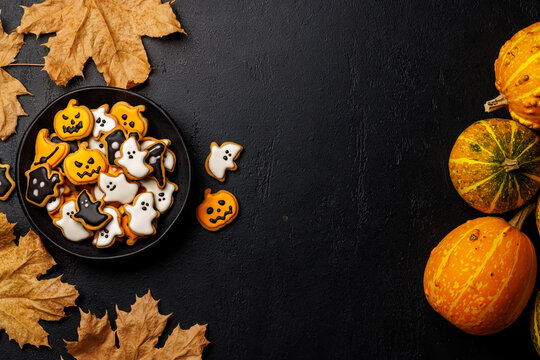 Halloween cookies on black stone background with copy space