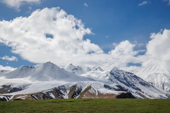 Snow covered mountains under blue sky