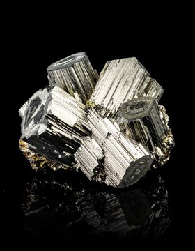 Metallic pyrite mineral cluster on black background.