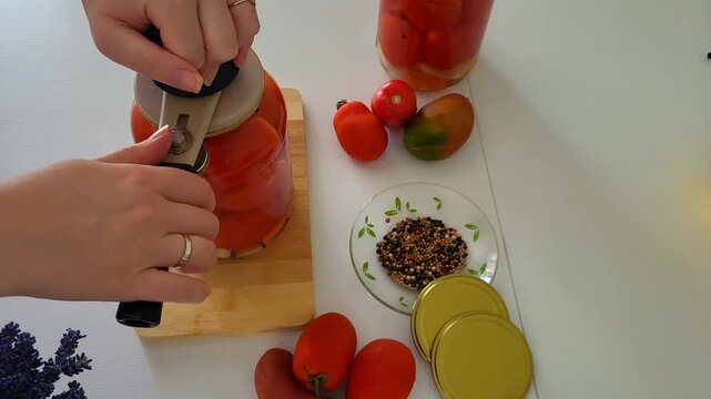 Traditional home canning process of organic tomatoes. Zero waste lifestyle, autumn harvest preparation, rustic DIY food preservation for family business
