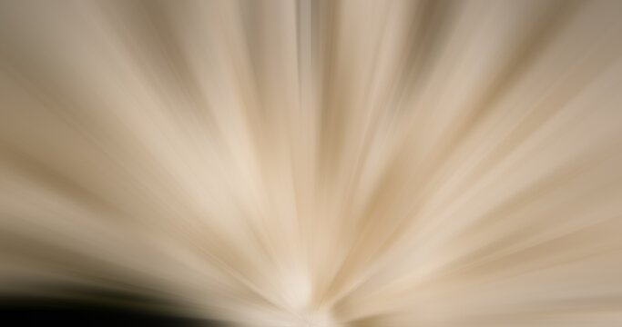 Abstract radial light ray background in brown beige tones. Dynamic motion blur zoom effect spreading from bottom for presentation, banner, and backdrop design